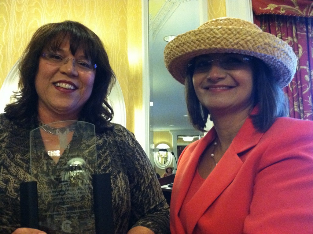 Donna Vincent Roa receives the 2011 Matrix Award from AWC-DC co-president Bina Handa