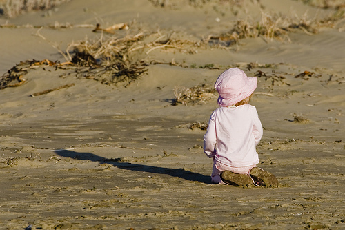 young toddler playing in the sand