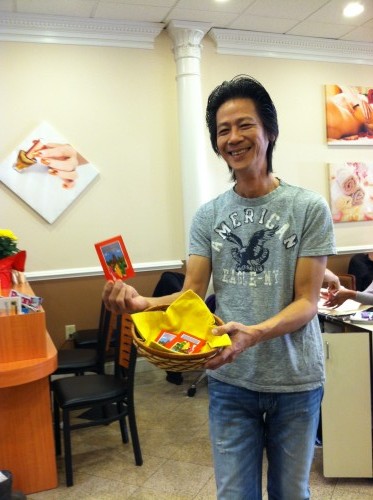 Pham holding lucky red envelopes for Chinese New Year 2013