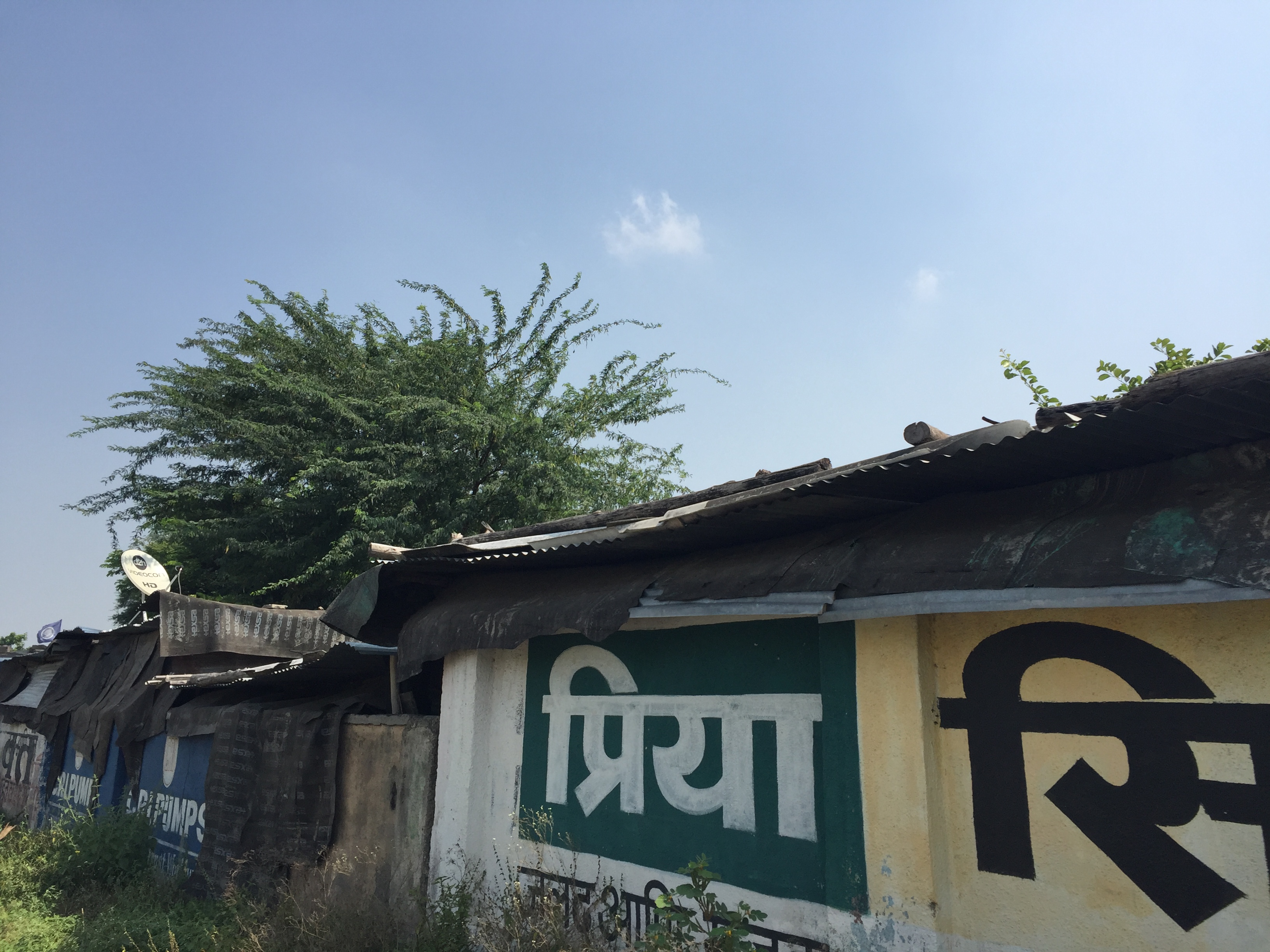 slum with satellite dish tells a story of India